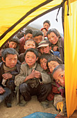 Children at tent entrance, curious to see western climbers. Kangri Garpo Mountains. South Eastern Tibet