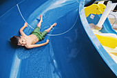 Boy in water slide in a cruise