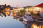 The illuminated Catches Waterfront Grille restaurant on the waterfront in the evening, Tampa Bay, Port Richey, Florida, USA