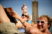 Young couple at a yetty at Lake Starnberg, Feldafing, Bavaria, Germany