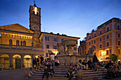 People sitting at a fountain at Piazza Sta Maria in the evening, Trastevere, Rome, Italy, Europe