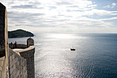 Lookout point from the city wall and fishing boat in the Adriatic Sea, Dubrovnik, Dubrovnik-Neretva, Croatia
