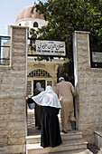 Women and man entering The Shrine of Saladin Mausoleum, Damascus, Syria. Asia
