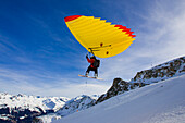 A man with snowboard using a Woopy-Jump, Grimentz, Valais, Switzerland
