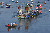 People in rowing boats, Boat procession at Corpus Christi at lake Staffelsee, Bavaria, Germany