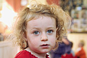 Three year old girl looking into camera, serious expression