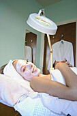 21 year old woman with a face mask on, smiling into camera , at the beauty therapy salon