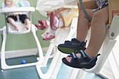Row of childrens feet in highchairs, at nursrey