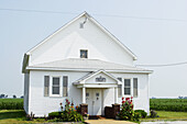 Small, rural, white Baptist church surrounded by corn fields. Arthur. Illinois, USA