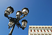 Puerto Rico, San Juan. Street lamp along Paseo de la Princesa, low angle view, part of older building