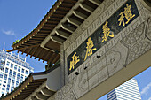 Massachusetts, Boston, Pagoda over entrance to Chinatown district in city, contrast with modern skyscrapers in background