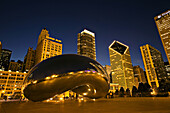 Illinois. Chicago. Cloud Gate sculpture in Millennium Park at night, city skyline, known as the Bean
