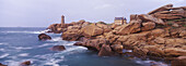 Granite coastline and lighthouse. Brittany, France
