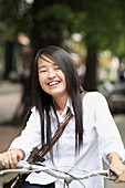 Portrait of teen smiling girl on bicycles. The Old Quarter, Hanoi, Vietnam, Indochina, Southeast Asia, Asia 2006