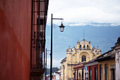 View of Antigua with San Pedro Apóstol church and Agua Volcano in the background. Antigua Guatemala. Sacatepéquez Region. Guatemala