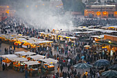 Food stalls and activity at sunset in DJemma El-Fna. Marrakech. Morocco.