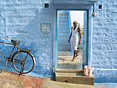 Man at house entrance in Jodhpur. Rajasthan, India