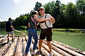 Couple dancing on a raft on the river Isar, Upper Bavaria, Germany