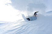 Young man snowboarding, Reutte, Tyrol, Austria