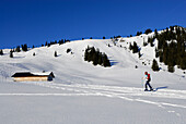 young woman ascending Schönkahler near hut Schönkahler Hütte (Pfrontner Alpe), Allgaeu range, Allgaeu, Schwabia, Bavaria, Germany