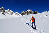 young woman ascending Haglertal with view to Satteltal, Allgaeu range, Allgaeu, Tyrol, Austria