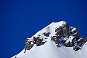 four backcountry skiers on deeply snow-covered summit of Woleggleskarspitze, Allgaeu range, Allgaeu, Tyrol, Austria