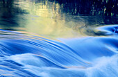 Autumn and blue sky reflections in rapids of Wanapitei river. Sudbury. Ontario. Canada