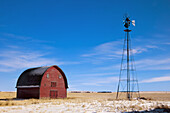 Red barn and windmill structure. Alberta, Canada