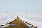 Wind Turbines on snowy prairie, with service road. Manitoba, Canada
