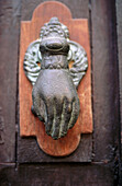 Antique door knocker with hand. San Miguel de Allende. Mexico.