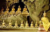 Buddha statues in underground cave. Petchaburi, Thailand.