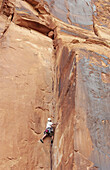 Rock climbing along the Colorado river near Moab, Utah, USA