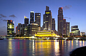 The Singapore skyline and Singapore River at dusk.