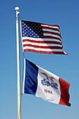 The American and Iowa State flags flying in Pella, Iowa, USA.