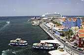 The port city of Willemstad, Curacao, Netherland Antilles with ferry boats and the cruise ship Adventure of the Seas.