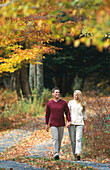 couple strolling on a country road in autumn