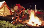 Couple by campfire