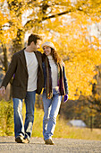 Couple smiling and walking country road
