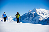 Two persons snowshoeing, Maennlichen, Grindelwald, Bernese Oberland, Canton of Bern, Switzerland