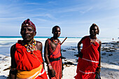 Three plastic Massai wearing traditional clothing at Diani Beach, Coast, Kenya