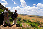 Tourists enjoying view over savannah, Voi Safari Lodge, Tsavo East National Park, Coast, Kenya