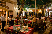 Life in the city, people sitting outside Rimi Restaurant at night enjoying an evening meal, Laiki Geitonia, Lefkosia, Nicosia, Cyprus
