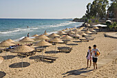 A young couple walking to the beach, Bogaz, North Cyprus, Cyprus
