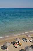 Two women sunbathing on Salamis Beach, Mimoza Beach Hotel, Salamis, North Cyprus, Cyprus