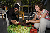 Monk, Priest selling fruit, Woman buying fruit at the market stall, Geroskipou, near Pafos, South Cyprus, Cyprus