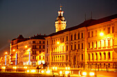 Illuminated street at night, city hall tower in background, Leipzig, Saxony, Germany