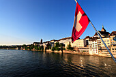 View of the Old City of Basel and the River Rhine, Swiss Flag in the foreground, Basel, Switzerland