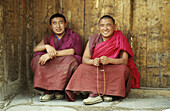 Two monks sitting at the door of Xigaze monastery. Xigaze, China