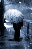 Man with umbrella in the rain on the Ile Saint Louis. Paris. France