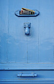 Blue door with letter drop and knocker. Cassis. France
